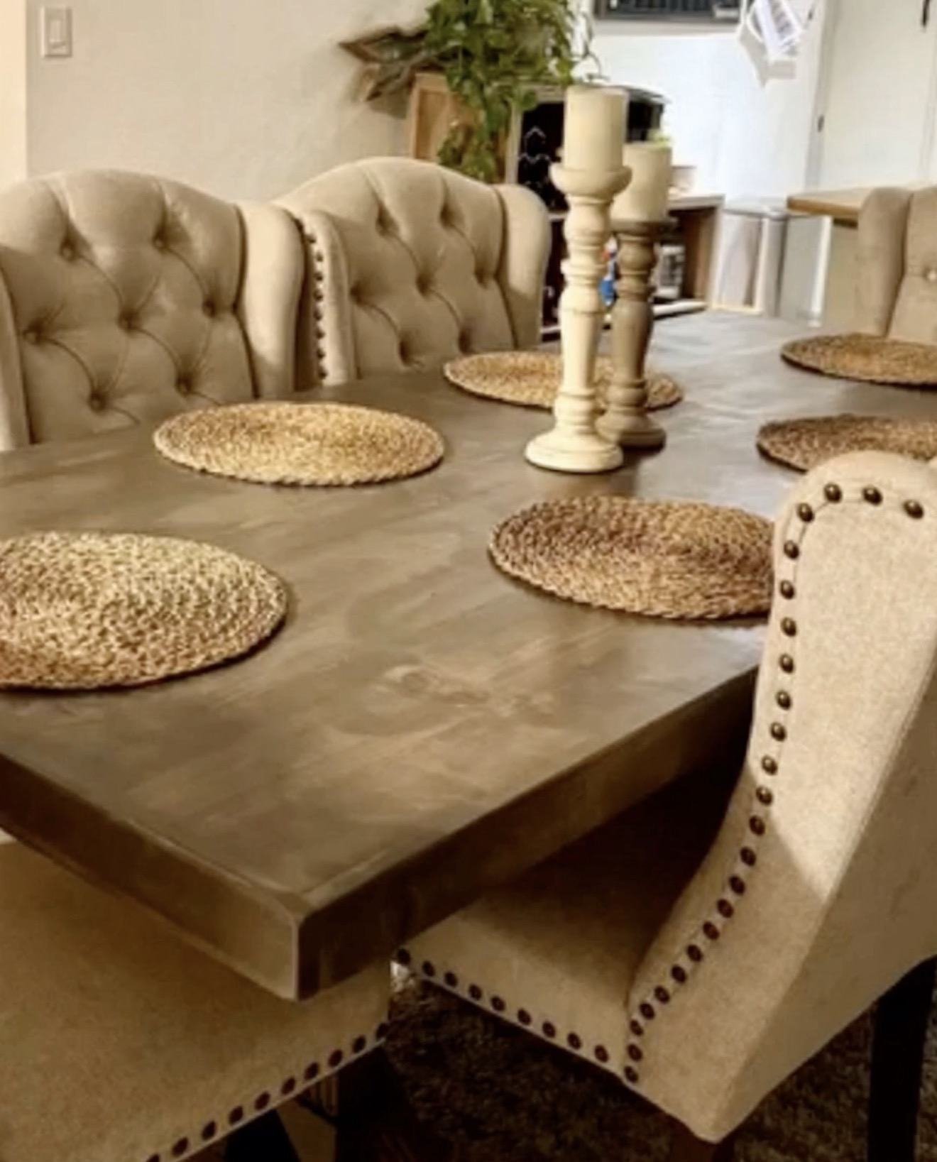 Close-up of a finished farmhouse tabletop showing wood grain, knots and the eased edge